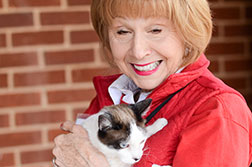Photo of a woman holding a cat.