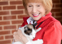 Photo of a woman holding a cat. Link to Life Stage Gift Planner Ages 45-65 Gifts. 45-65.jpg